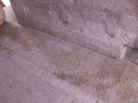 1995 Ford C-350 (Centurion Conversions) - Close-up view of the interior carpet and the base of a seat.