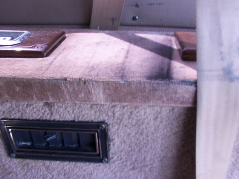 1995 Ford C-350 (Centurion Conversions) - Interior view showing carpeted surfaces, a vent, and decorative accents.
