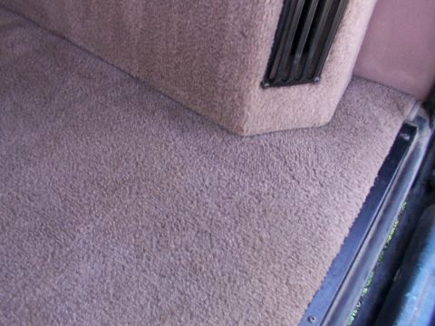 1995 Ford C-350 (Centurion Conversions) - Close-up of the carpeted interior and an air vent.