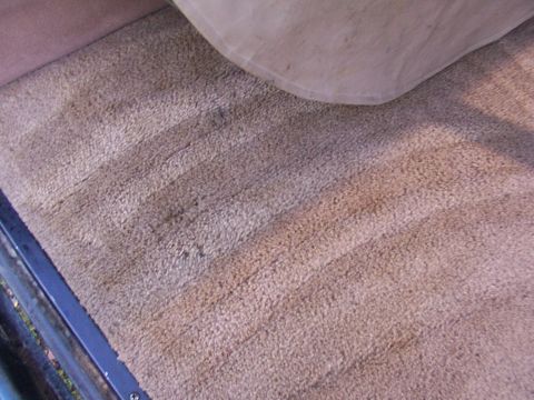 1995 Ford C-350 (Centurion Conversions) - The worn carpet on the floor of the vehicle shows signs of age and use.
