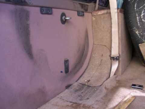 1995 Ford C-350 (Centurion Conversions) - Spare tire and interior trim visible in the cargo area of a vehicle.
