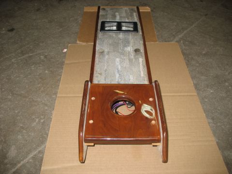 1995 Ford C-350 (Centurion Conversions) - A wooden console with a circular opening revealing wires and two digital displays is placed on cardboard.