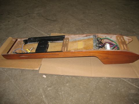 1995 Ford C-350 (Centurion Conversions) - The interior of a wooden overhead console shows wiring, connectors, and black electronic modules.
