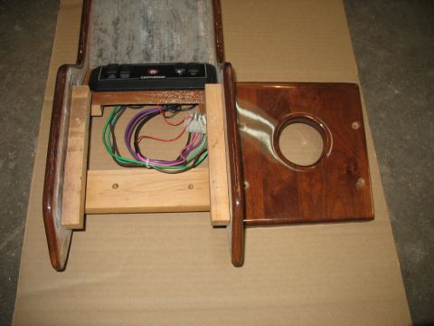 1995 Ford C-350 (Centurion Conversions) - Close-up of a vehicle's overhead console, showing wiring and a wood-grain panel with a circular opening.