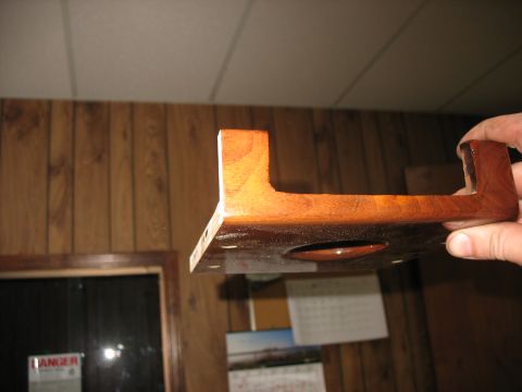 1995 Ford C-350 (Centurion Conversions) - Wooden part, possibly a bracket, held up for inspection.