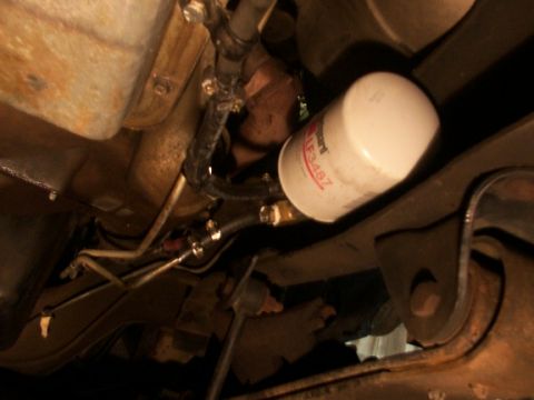 1995 Ford C-350 (Centurion Conversions) - A close-up shot shows a Wix 51348Z oil filter attached to hoses and other vehicle undercarriage components.