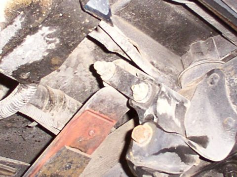 1995 Ford C-350 (Centurion Conversions) - Close-up view of vehicle suspension components, showing leaf springs and mounting hardware.