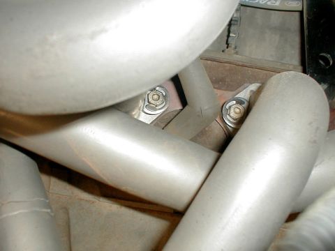 1996 Ford Bronco - Detail shot of exhaust manifold pipes, showing fasteners and connections.