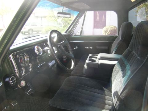 1996 Ford Bronco - The interior of a classic pickup truck features plush seats, a custom steering wheel, and a functional dashboard with multiple gauges.