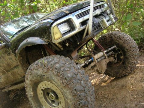 1989 Ford Bronco - This heavily modified off-road vehicle is covered in mud, suggesting it has been used for extreme terrain.