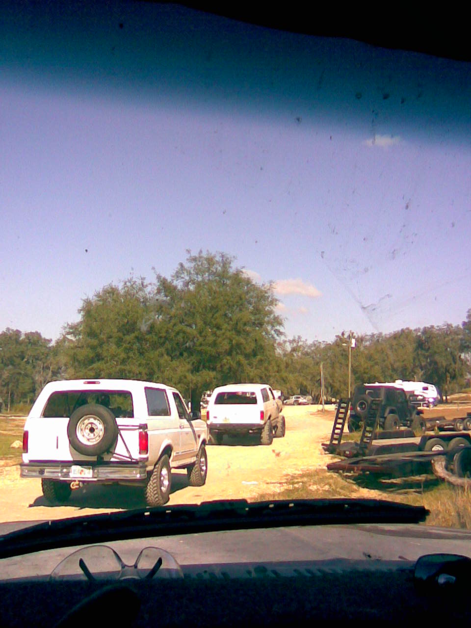 White SUV with spare tire on rear, seen from behind