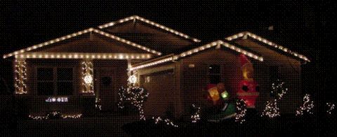 1971 Ford Bronco - A house is adorned with festive Christmas lights, illuminating the night.