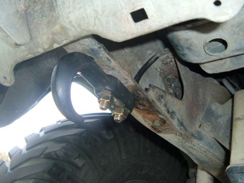 1981 Ford Bronco - Vehicle frame with a tow hook and tire visible. Year is not determinable from this view.