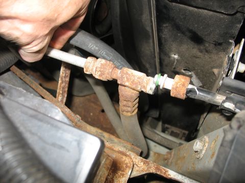 1995 Ford C-350 (Centurion Conversions) - Close-up of a rusty AC condenser hose fitting, showing a 1/2" (13mm) HEA hose.