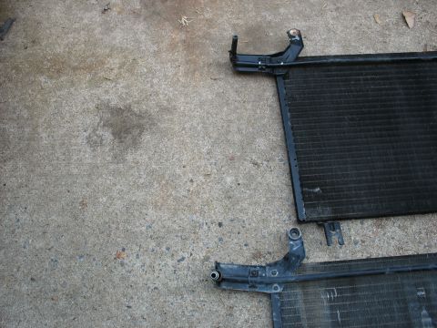 1995 Ford C-350 (Centurion Conversions) - Two car AC condensers are shown resting on a concrete surface, likely removed for repair or replacement.