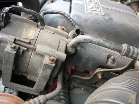 1995 Ford C-350 (Centurion Conversions) - Engine bay detail showing an AC compressor and a turbo diesel engine cover.