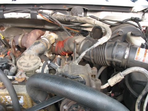 1995 Ford C-350 (Centurion Conversions) - Close-up view of an engine bay, highlighting the turbocharger and associated intake plumbing.