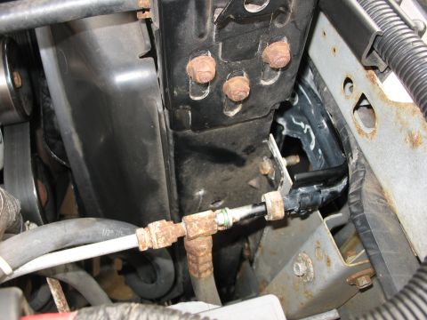 1995 Ford C-350 (Centurion Conversions) - Close-up view of AC condenser lines, showing some text on a hose.