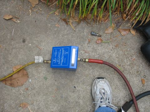 1995 Ford C-350 (Centurion Conversions) - A blue air vacuum pump is set up on a concrete surface with hoses attached.