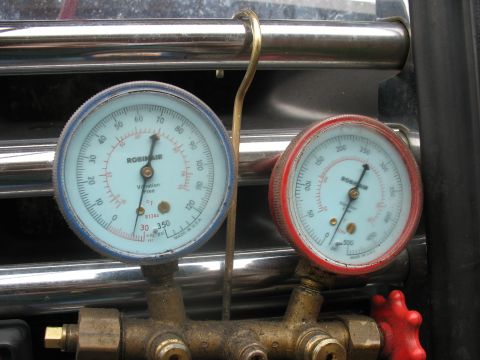 1995 Ford C-350 (Centurion Conversions) - AC manifold gauge set with two gauges, one blue and one red, displaying pressure readings for R134a refrigerant.