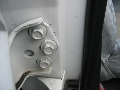 1995 Ford C-350 (Centurion Conversions) - The photo shows the bolts securing the door hinge to the vehicle's frame.