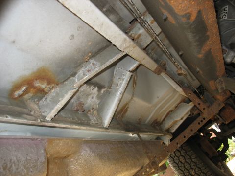 1995 Ford C-350 (Centurion Conversions) - The underside of the vehicle shows significant rust and wear on the frame components.
