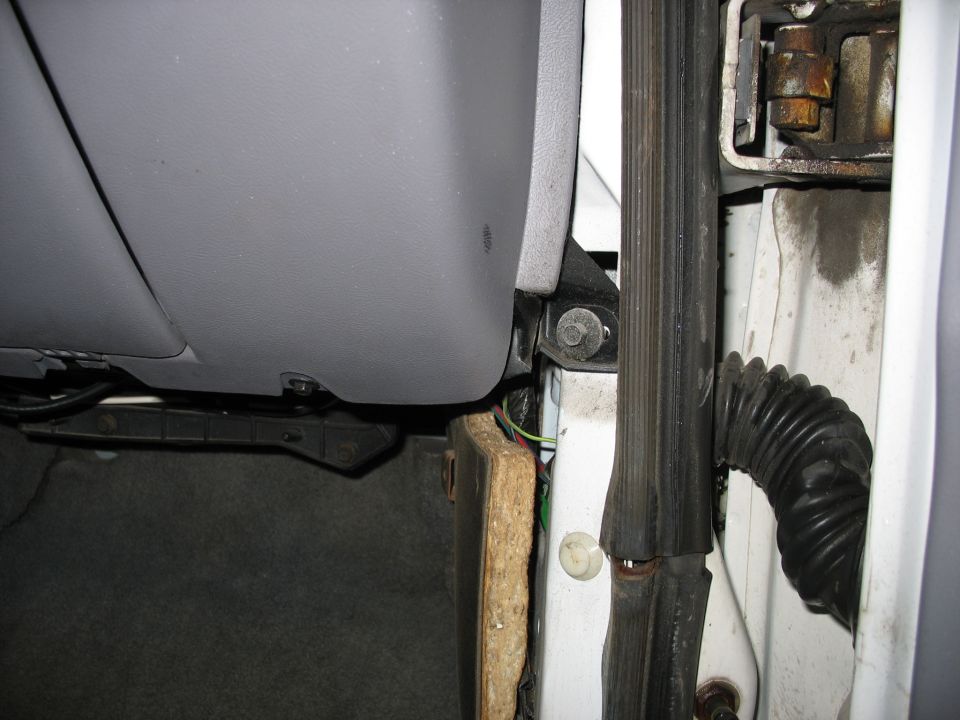 Interior door jamb and dash panel with exposed wiring and insulation