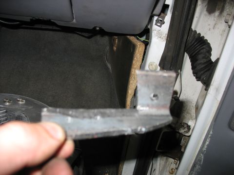 1995 Ford C-350 (Centurion Conversions) - Close-up of a metal bracket, possibly for dash repair, held in hand.