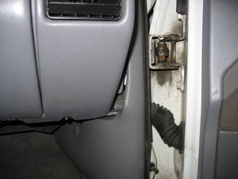 1995 Ford C-350 (Centurion Conversions) - Close-up view of the interior door jamb and dashboard area, revealing a rubber boot and gray trim panels.