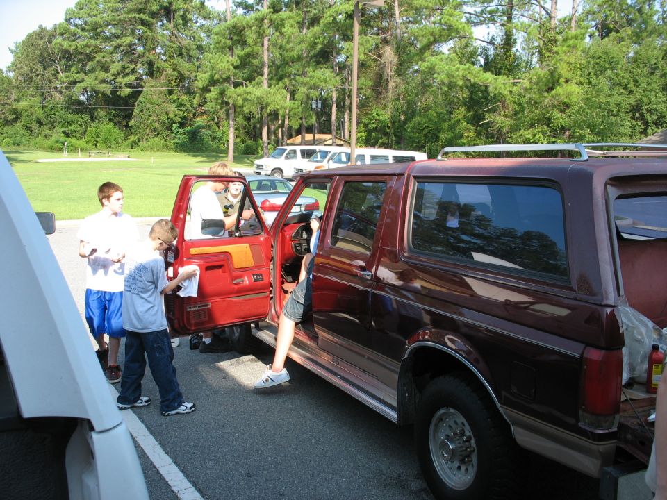 Maroon 1995 Ford C-350 Centurion Conversions SUV with doors open