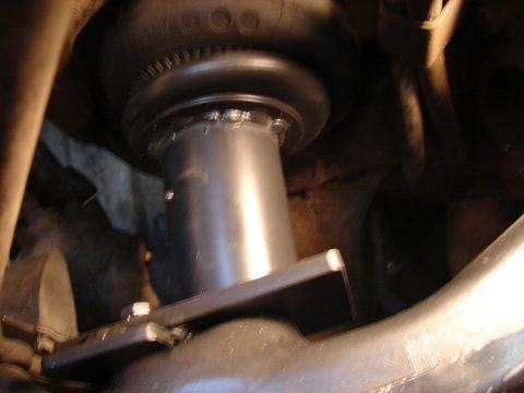 1973 Ford Ranchero - Underbody close-up of a coil spring seat area with a fabricated steel spacer or perch welded beneath a rubber bump stop, photographed from…