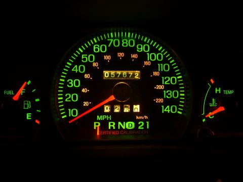 2005 Ford Crown Victoria - The illuminated dashboard gauges show the odometer reading of 57,672 miles and the gear selection of Park, Reverse, Neutral, Drive, and 21.