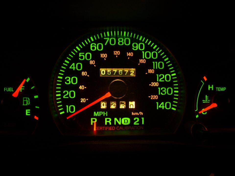 Green-lit car speedometer cluster, odometer 057672, fuel and temp gauges, PRND21 indicator