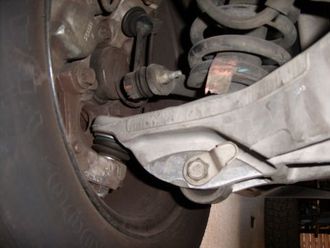 2005 Ford Crown Victoria - This image shows the underside of a vehicle's suspension system, focusing on the wheel assembly and related components.