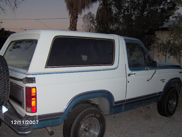 White and blue two-tone Ford Bronco rear three-quarter at dusk