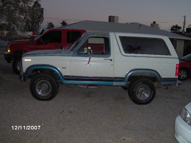 White and blue Ford Bronco side profile at dusk