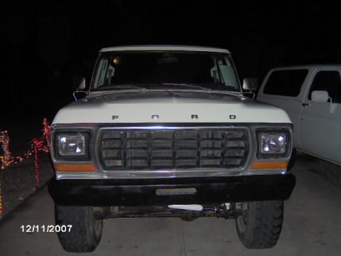 1979 Ford Bronco - 1979 Ford F-150 truck front end, with a second vehicle in the background.