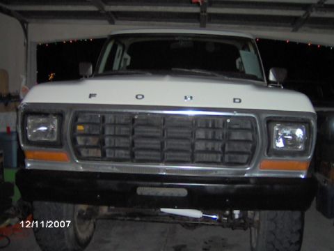 1979 Ford Bronco - Front view of a white 1979 Ford Bronco, its distinctive grille and headlights.