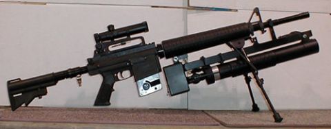 2001 Ford Crown Victoria - An assault rifle is shown with a scope and a grenade launcher attachment, along with a "SUPERMOTORS" watermark.