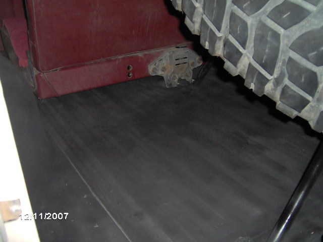 Maroon interior panel and spare tire in a vehicle