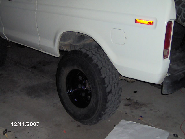 White SUV rear quarter panel, tire, and taillight. Appears to be a 1978 model