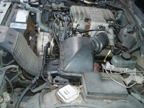 1991 Ford LTD Crown Victoria - Close-up view of a V8 engine bay, showing various components and the air intake system.