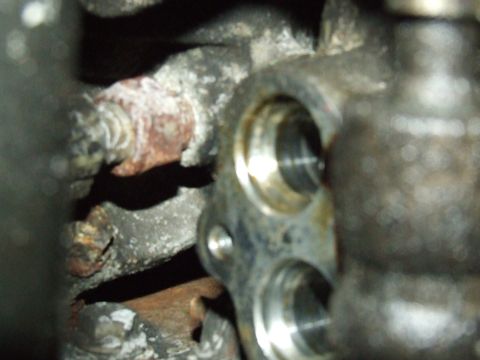 2003 Ford Crown Victoria - This is a close-up view of a mechanical part, possibly from an engine, showing signs of wear and corrosion.