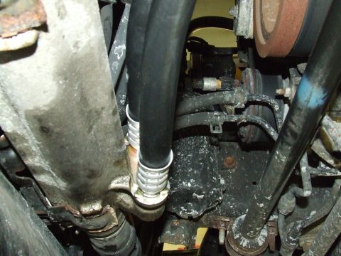 2003 Ford Crown Victoria - Close-up view of engine oil cooler lines and associated plumbing.