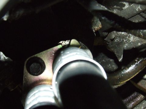 2003 Ford Crown Victoria - This is a close-up view of a vehicle's oil cooler line connection.