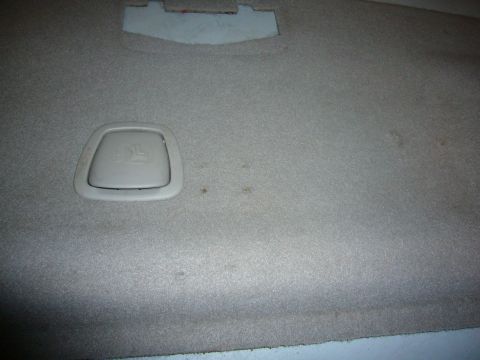 2000 Ford Crown Victoria - Close-up of interior carpeting a beige latch anchor and some minor stains.