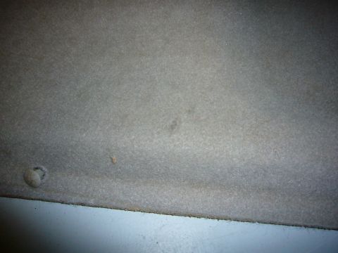 2000 Ford Crown Victoria - The image shows a close-up of the textured interior upholstery of a vehicle, with a visible screw head.