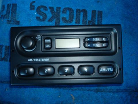 2001 Ford Crown Victoria - Close-up of a car's AM/FM stereo radio unit with various control buttons and a digital display.