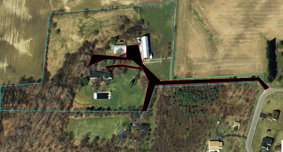 Aerial satellite view of a rural property with marked driveway