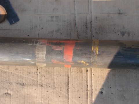 1968 Shelby GT500 - A close-up view of a metal bar with various paint marks, possibly indicating assembly or repair details.